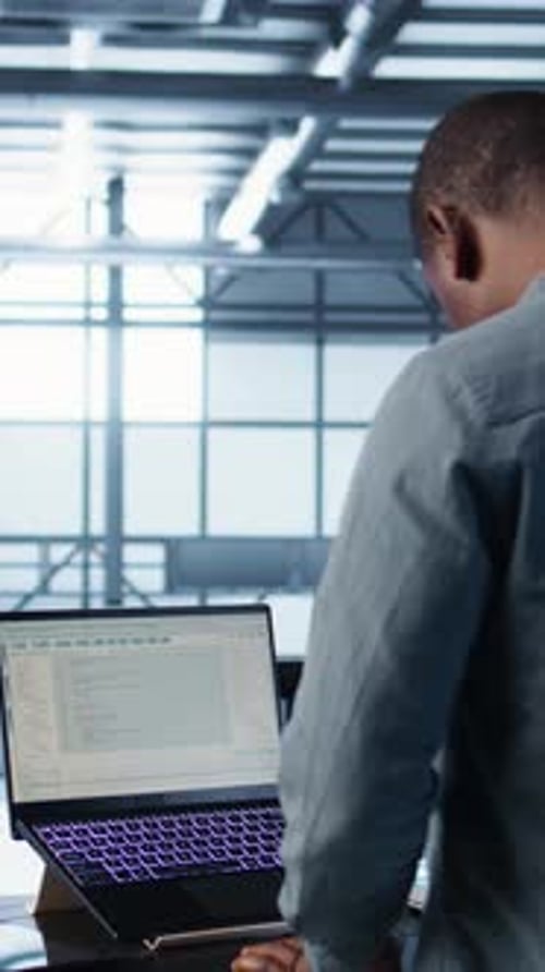 Vertical Video Data Center Engineer Coding on Notebook Adjusting Power Settings