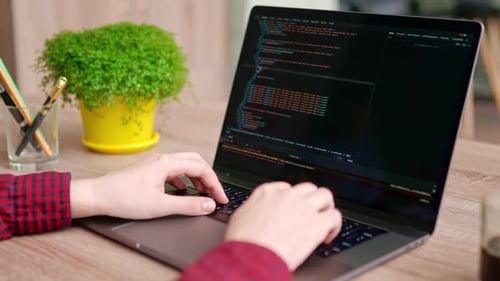 Close Up of Freelancer's Hands Typing Code on Laptop Keyboard Camera Slides Around Developer's