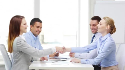 Business, Office, Teamwork and Startup Concept - Smiling Business Team with Table