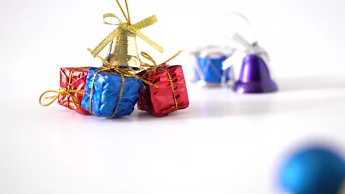 Close up view and panning studio shot of Christmas decorations on white background : Golden ribbons,