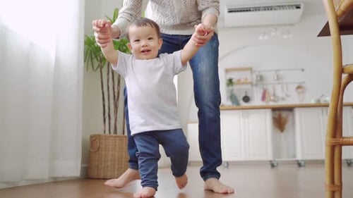 Asian Little toddler boy learning to walk