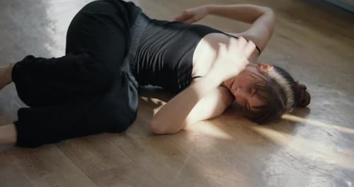 Woman Practicing Floor Stretching in Light Filled Room