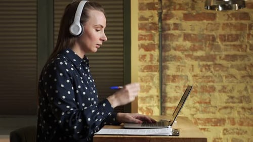 Side View Young Woman a University Student Studies Online Using a Laptop Computer