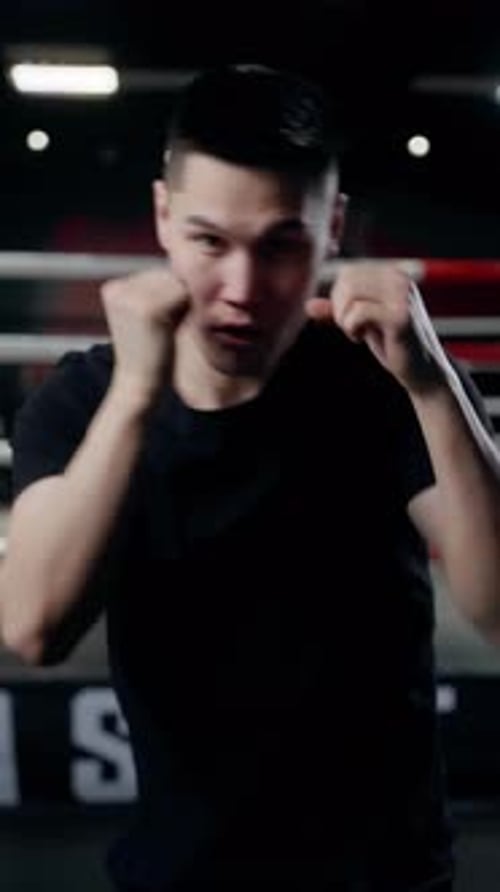 Young Adult Man Practicing Boxing in Gym