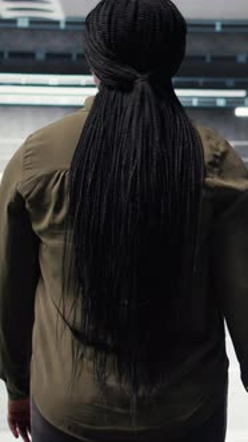 Vertical Video Woman Walking Through Data Center Server Rows Checking Equipment