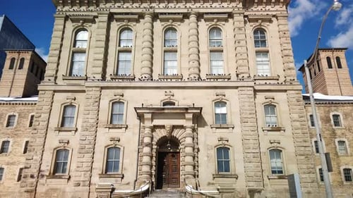 A wide shot of the Old Don Jail in Toronto, tilting upwards to the sky