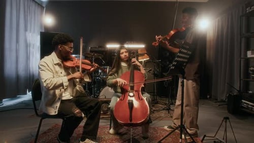 String Trio Practicing Music in Studio