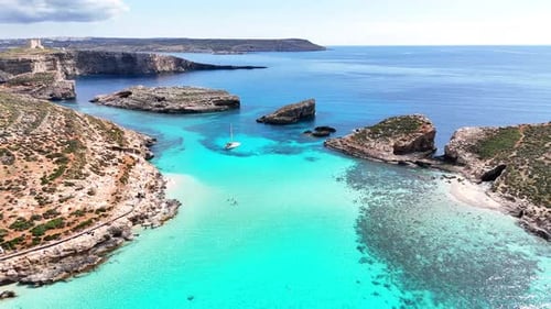 Drone recule au-dessus du canal Blue Lagoon et de l'îlot Cominotto (Comino Malta)