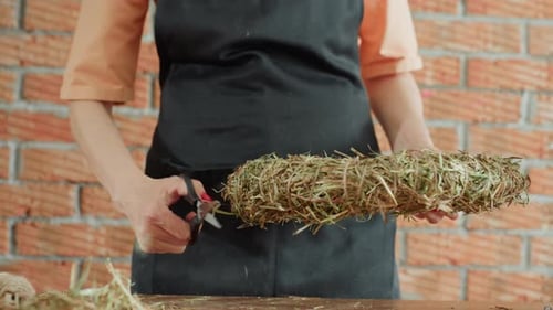 Woman Creates Wreath with Twine and Natural Materials