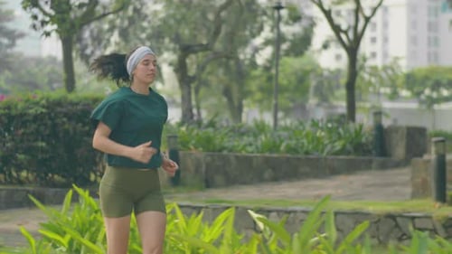 Fit Woman on Morning Run in City