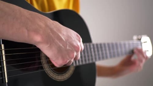 Hands Strumming Acoustic Guitar Close Up Indoors