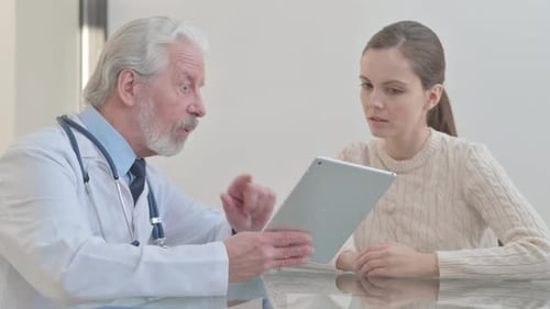 Doctor Consults Patient with Tablet in Bright Office