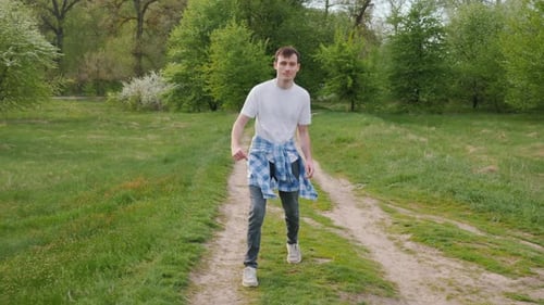 A Cool Man is Rehearsing a Cheerful Dance in Nature Having Fun