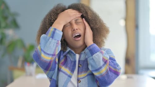 Young Woman Massaging Temples Due to Headache
