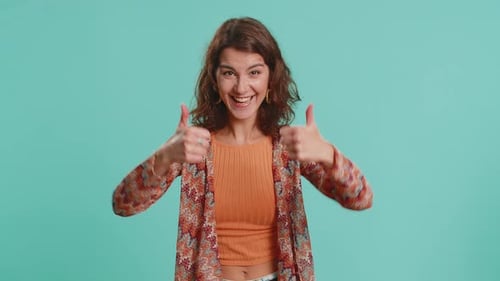 Young Woman Raises Thumbs Up Agrees or Gives Positive Reply Recommends Advertisement Likes Good Idea