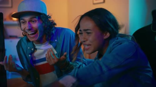 Excited young adults in front of computer screen