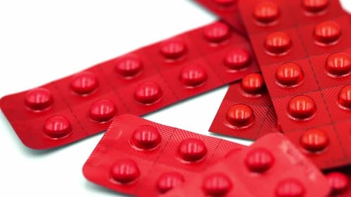 Red Pills in Blister Packs Close Up