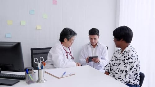 Doctors Reviewing Medical Information with Patient