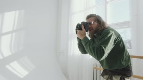 Photographer Giving Directions to Model during Photo Session in Studio