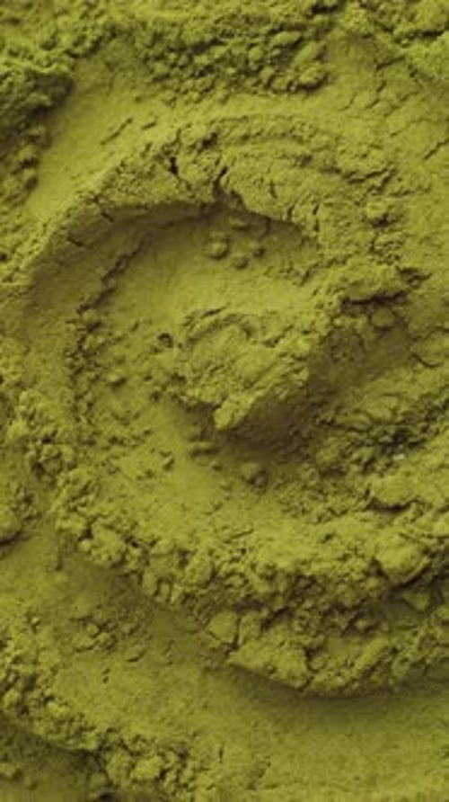 Green Chlorella Algae Powder on a Wooden Spoon Top View Healthy Nutritional Supplement