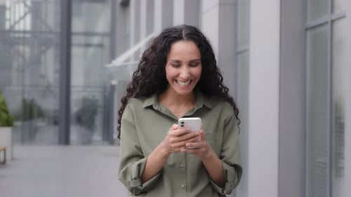 Woman Reacts with Joy to Content on Phone