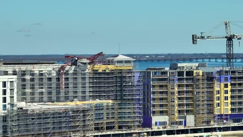 Aerial View of Ruined By Hurricane Ian Construction Crane on High Apartment Building Site in Port
