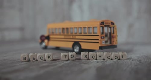 The Words Back To School On The Background Of A School Bus