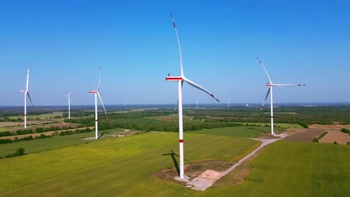 Aerial view of wind turbines in green field