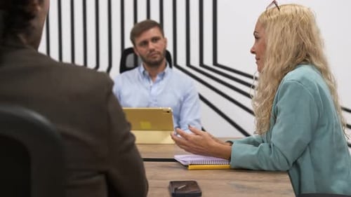 Woman Leads Meeting in Modern Office