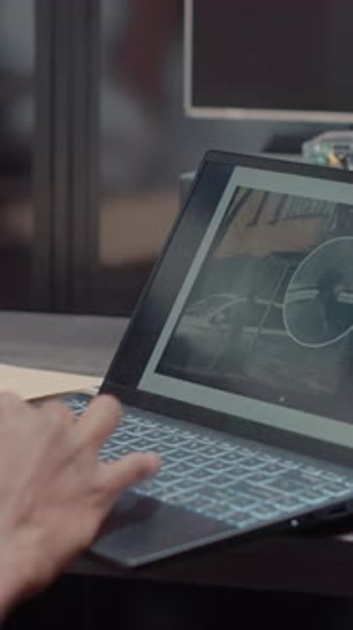 Hand Typing on Laptop Keyboard in Office