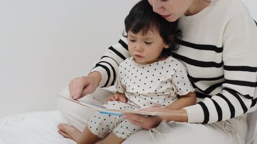 Mother and Child Reading a Book at Home