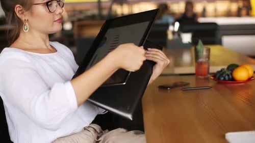 Mixed Race Freelancer Transforms Convertible Laptop Into Tablet While Working in Cafe Asian