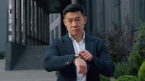 Portrait Serious Asian Business Man in City Showing Late Time on Wristwatch Korean Businessman