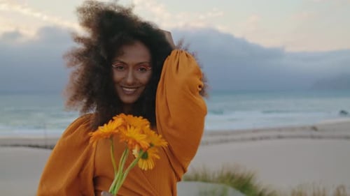 Portrait Girl Posing Seashore with Orange Flowers