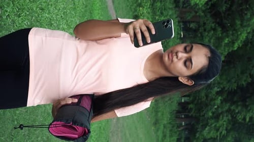 KOLKATA,INDIA:-Caucasian sporty girl young adult in her 20 s with yoga mat isolated on outdoor backg