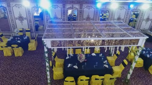 The elegant view captures a dining area complemented by a stunning fake ceiling adorned with hanging