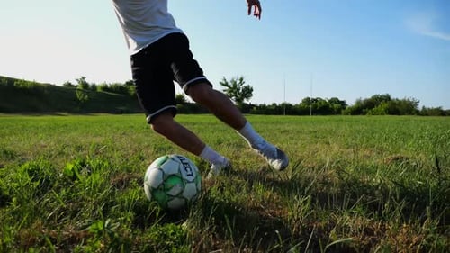 Professional Footballer in Uniform Shows Tricks with Ball While Running at Green Field Sportsman