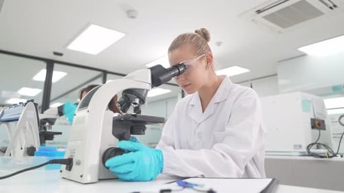 Researchers work in a lab on a project involving samples and equipment in a controlled environment