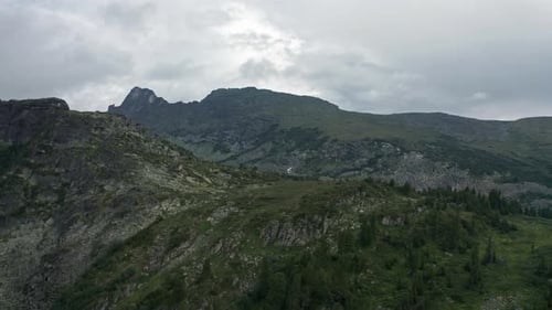 A Majestic Mountain Range Embraced By a Dramatic CloudStreaked Sky