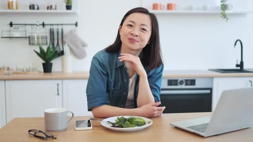 Woman Smiling in her Bright Kitchen