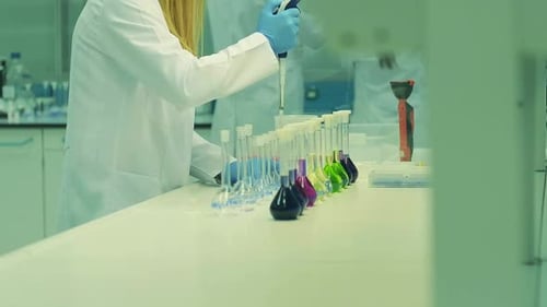 Scientists Conduct Research in Laboratory with Colorful Chemicals