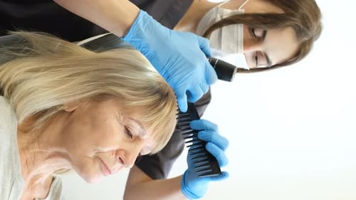 A Trichologist Works with a 60Yearold Female Client in a Modern Clinic