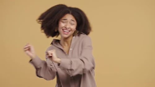 Woman Dancing with Joyful Celebration in Studio