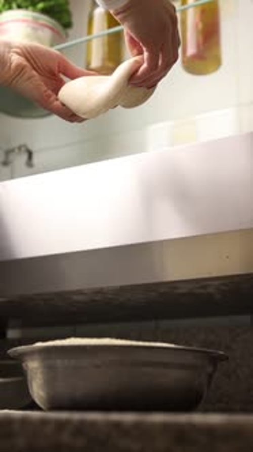 The chef makes delicious pizza in a professional kitchen.