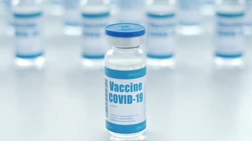 Covid 19 coronavirus vaccine vial close up in medical pharmaceutical lab