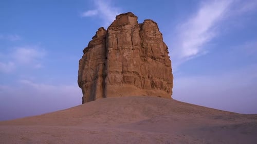 Natural sandstone cliff in middle of desert isolated on blue sky, static view