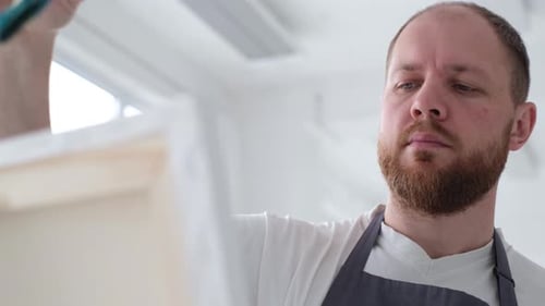 An Artist Paints a Piece of Art on a Canvas with Color Oil Painting at Home An Artist Works and