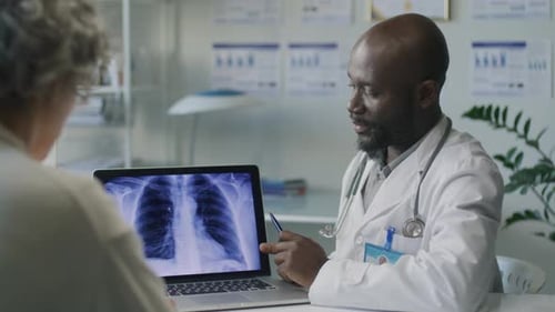 Doctor Explains Chest X-Ray to Patient in Office
