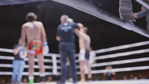 A Boxing Match is in Progress with a Referee and Two Fighters