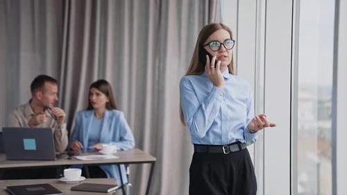 Young Woman Talking on Phone in Office